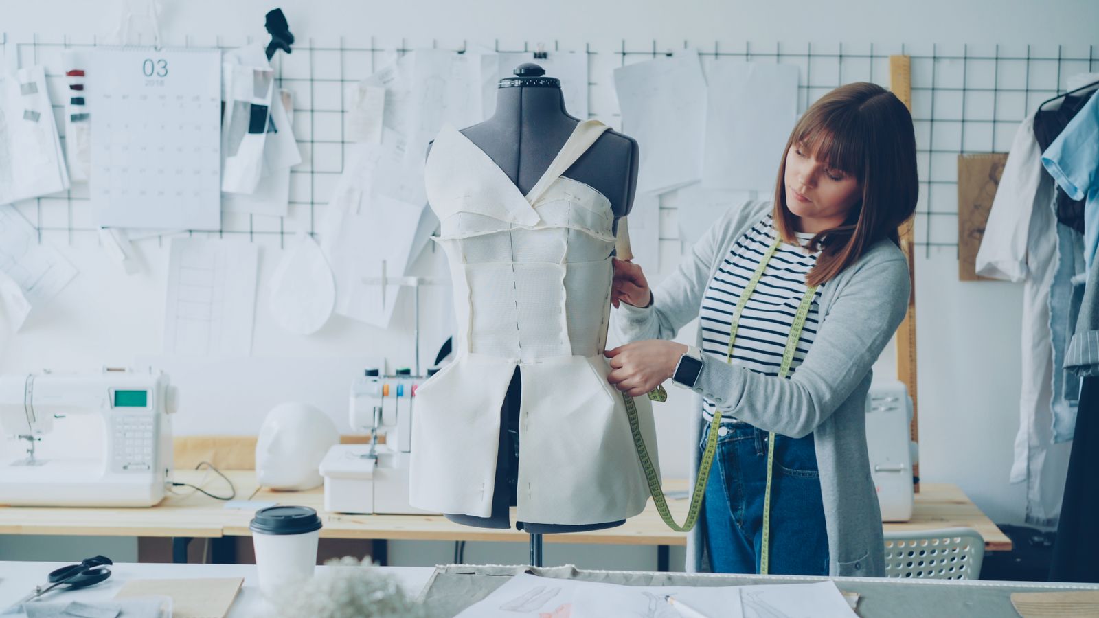 Lupita measuring a piece on the form